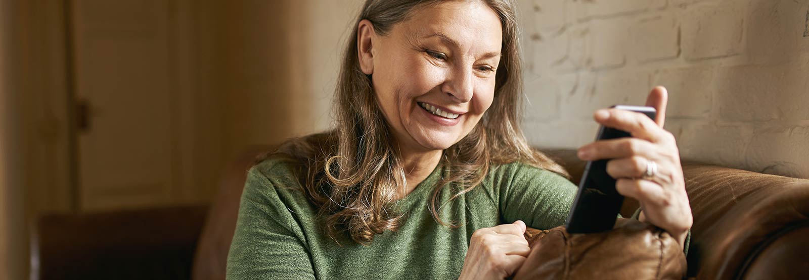 Lady using her smartphone in her home