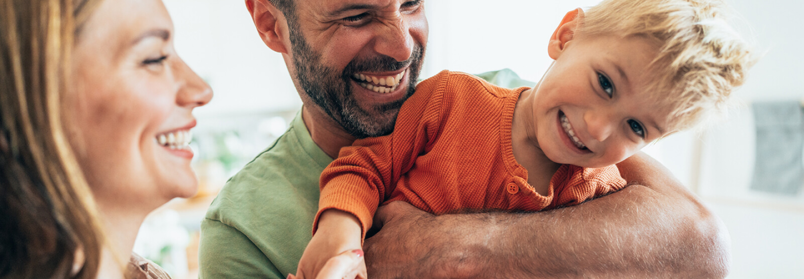 couple with young son laughing
